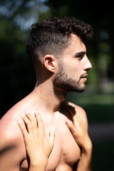 Naklejka premium young handsome European man topless with asian girlfriend