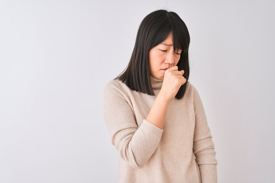 Young beautiful chinese woman wearing turtleneck sweater over isolated white background feeling unwell and coughing as symptom for cold or bronchitis. Healthcare concept.
