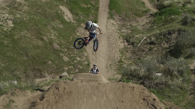 Aerial view of boys jumping hill on bicycles at bike park / Salt Lake City, Utah, United States