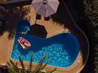 man on beach mat in swimming pool of a villa house