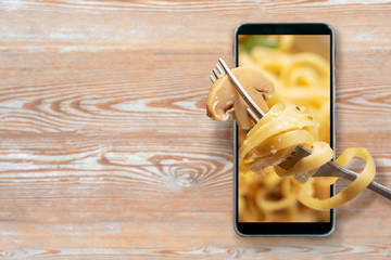 Order and food delivery from your smartphone. Smartphone on wooden background