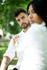 asian woman rejecting an European man in the park