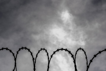 barbed wire and cloudy sky