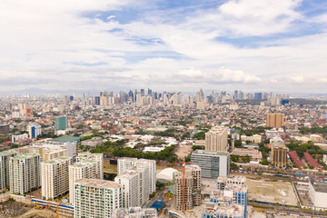 Fototapeta na wymiar The city of Manila, the capital of the Philippines. Modern metropolis in the morning, top view. New buildings in the city. Panorama of Manila. Skyscrapers and business centers in a big city.