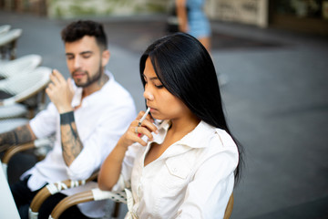 mix couple asian and European smoking during the breakfast in the street
