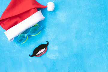 Hat of Santa Claus with goggles for swimming and the moustache and the smile. Christmas vacation,...