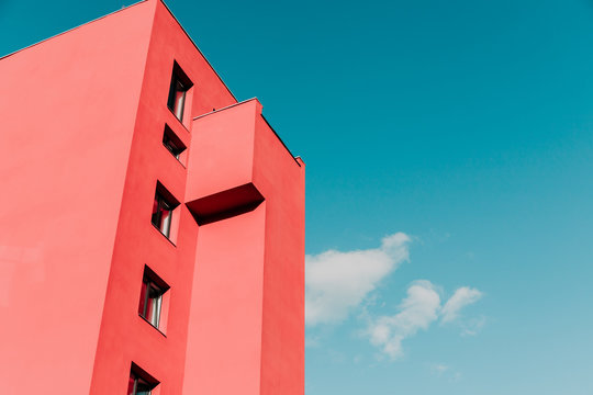 View from below on a pink modern house and sky. Vintage pastel colors, minimalist concept.