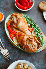 Festive dish for Thanksgiving, roasted turkey legs with vegetables on a table with snacks.