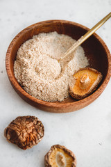 Rowder is made from Chinese dried mushrooms Shiitake in a wooden bowl on a table. The concept of medicinal additive for healthy food.