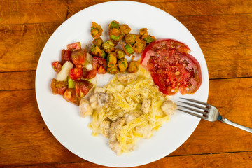 Chicken Pasta Dinner with Fresh Garden Vegetables on Rustic Table