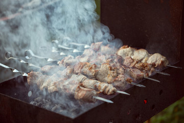 Skewers are cooked on charcoal on the grill. Pork meat on skewers.