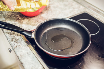 thin stream of sunflower oil in a hot frying pan