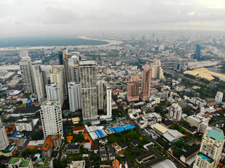 Fototapeta na wymiar Bangkok Metropolis, aerial view over the biggest city in Thailand. Bangkok skyline from Sukhumvit street. Aerial view of Bangkok skyline and skyscraper. Thailand