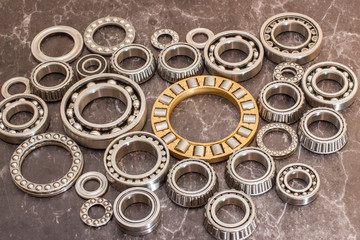 Various bearings on a black concrete background.