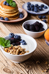 Morning meal, homemade granola with yogurt, fresh summer berries, fruits