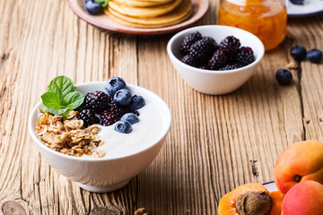 Morning meal, homemade granola with yogurt, fresh summer berries, fruits
