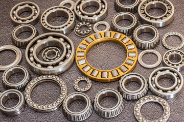 Various bearings on a black concrete background.
