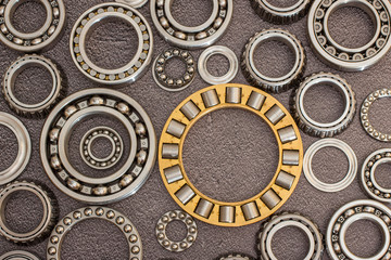 Various bearings on a black concrete background.