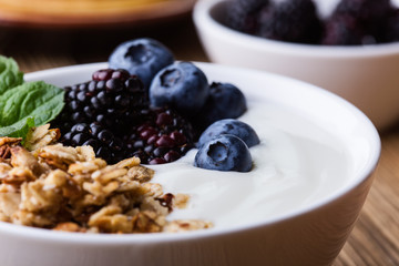 Morning meal, homemade granola with yogurt, fresh summer berries, fruits