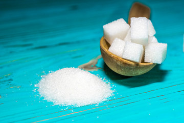 White sugar refined and crystallized on a blue background.