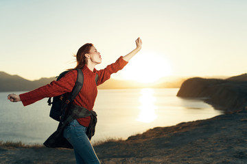 happy woman with arms outstretched on the beach