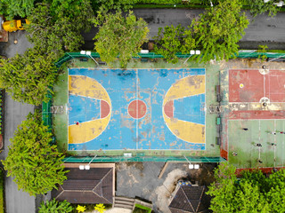 Aerial view of basketball court with players in public park in Bangkok. Top view of basketball court