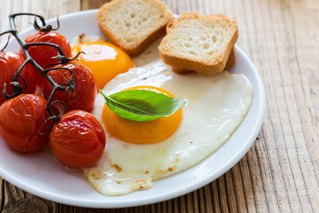  Fried eggs with cherry tomatoes, fresh summer fruits, berries, coffee and juice