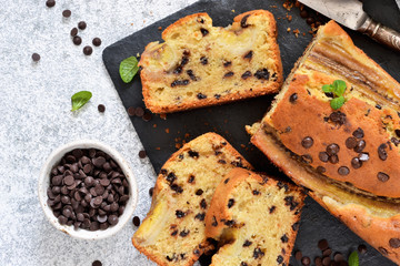 Banana cake with chocolate drops on the kitchen table. Classic dessert.
