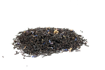 Dry black tea with blue flowers leaves isolated on white