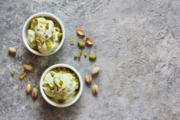 Pistachio ice cream with mint on a stone background. Green ice cream. View from above.