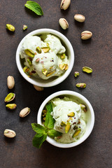 Pistachio ice cream with mint on a stone background. Green ice cream. View from above.