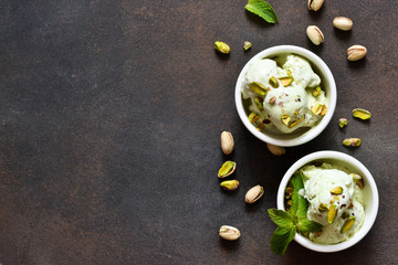 Pistachio ice cream with mint on a stone background. Green ice cream. View from above.