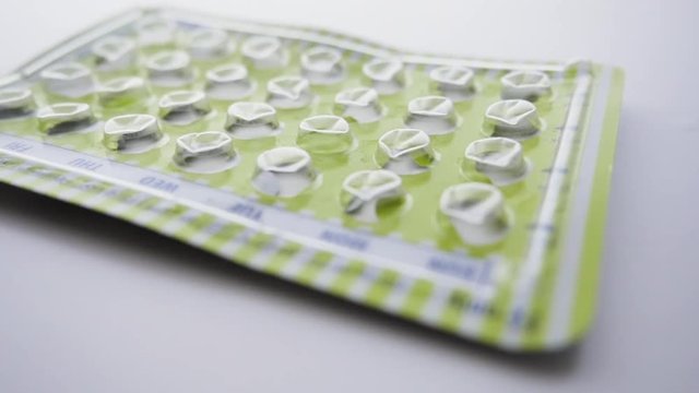 Empty package of birth control pills drops. Oral contraceptives prevent unwanted pregnancy and are the lynchpin of women's reproductive rights.