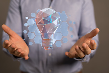  holding illuminated light bulb, idea, innovation and inspiration concept.