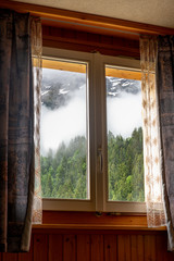 Beautiful view over alps through Chalet window