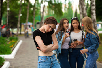 Four schoolgirls in summer park