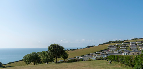 Beer, Seaton, Devon, England, UK. July 2019.  Caravan park at Beer Head on high ground and overlooking the sea with a clear blue sky.