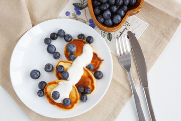 pancake with blueberries and sour cream