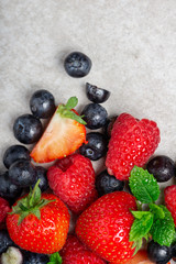 Fresh summer berries such as blueberries, strawberries, raspberries, top view