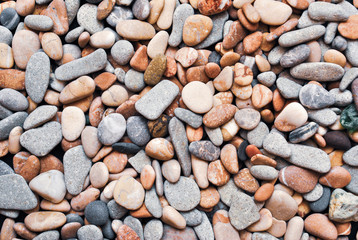Multicolored colorful sea pebbles, natural background, texture. Close-up texture of colorful sea pebbles. Small Rock. Sea background