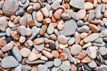 Multicolored colorful sea pebbles, natural background, texture. Close-up texture of colorful sea pebbles. Small Rock. Sea background