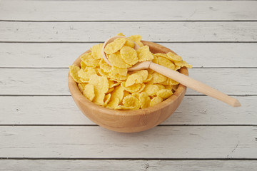 Rolled oats, healthy breakfast cereal oat flakes in bowl on wooden table