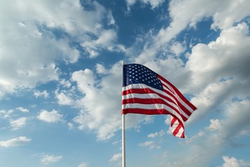American Flag Waving Against Blue Sky
