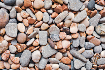 Multicolored colorful sea pebbles, natural background, texture. Close-up texture of colorful sea pebbles. Small Rock. Sea background