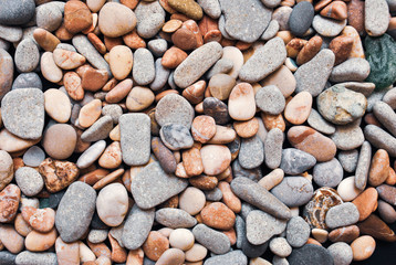 Multicolored colorful sea pebbles, natural background, texture. Close-up texture of colorful sea pebbles. Small Rock. Sea background