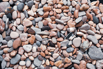 Multicolored colorful sea pebbles, natural background, texture. Close-up texture of colorful sea pebbles. Small Rock. Sea background