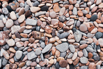 Multicolored colorful sea pebbles, natural background, texture. Close-up texture of colorful sea pebbles. Small Rock. Sea background