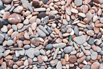 Multicolored colorful sea pebbles, natural background, texture. Close-up texture of colorful sea pebbles. Small Rock. Sea background
