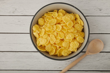 Rolled oats, healthy breakfast cereal oat flakes in bowl on wooden table