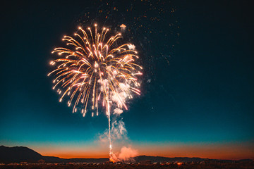 Fireworks in sky at sunset